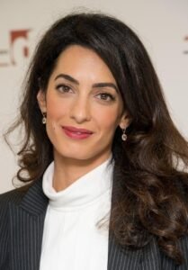 Amal Clooney international human rights lawyer posing for a professional portrait.