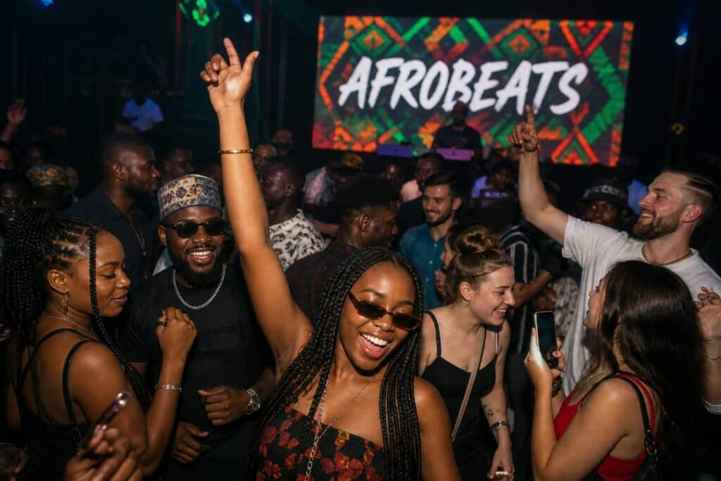 Crowd dancing in a nightclub as Afrobeat music plays, with people of different cultures enjoying the vibe.