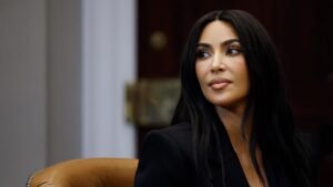 Kim Kardashian posing in professional legal-style attire while studying law.